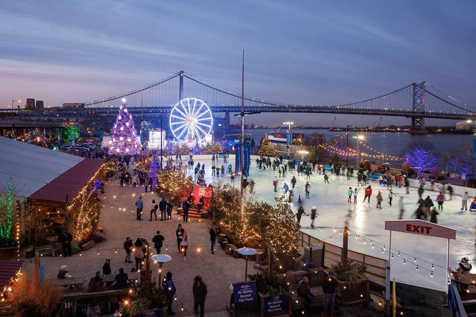 Holiday environment with all lights and people enjoying skating on Ice rink